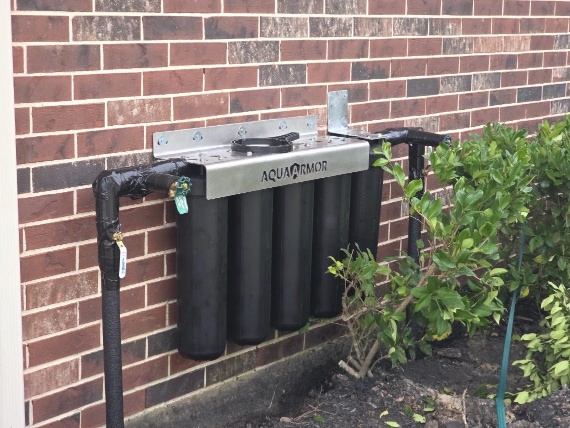 Finished AquaArmor whole-house water filtration system installed in a garage
