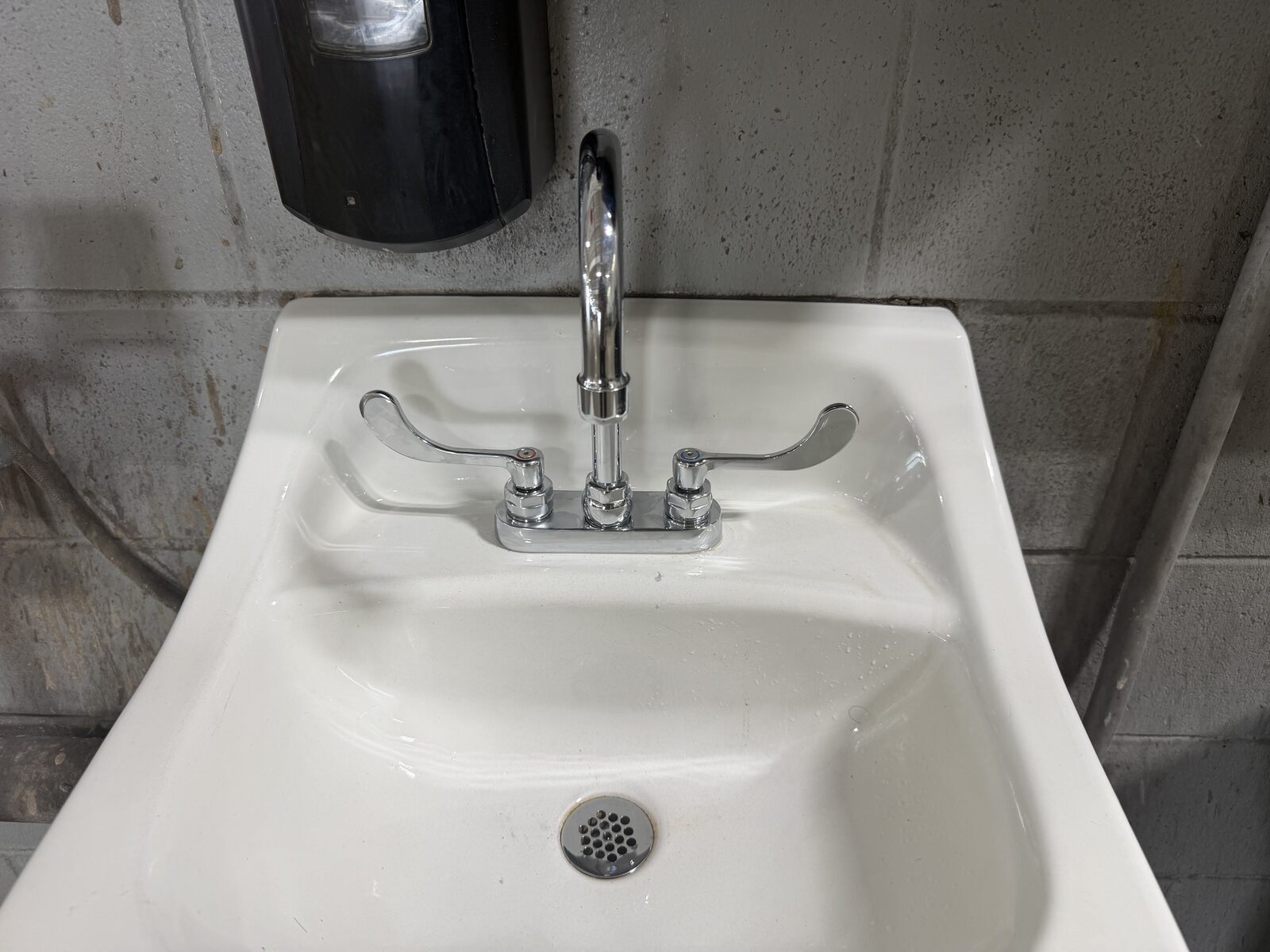 Wrist blade faucet on a commercial lavatory