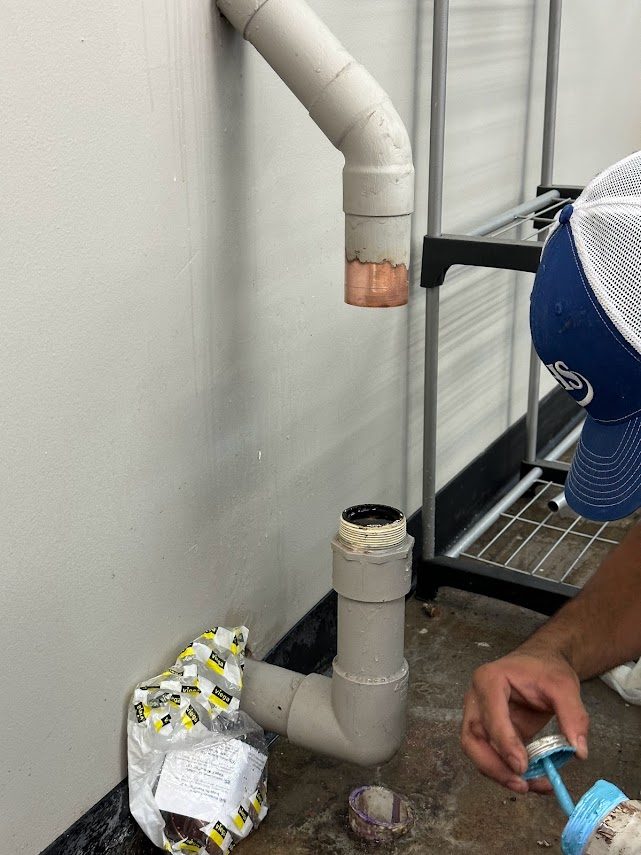 Old commercial water line cut open with the joint being prepared for repair