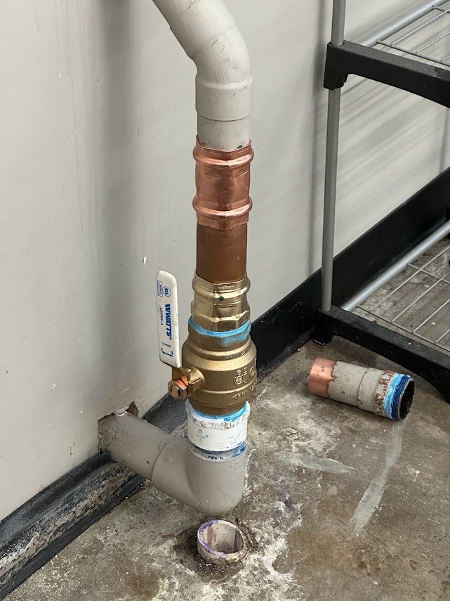 New Watts valve and pressed copper installed on a commercial water line, cut-out section on the floor