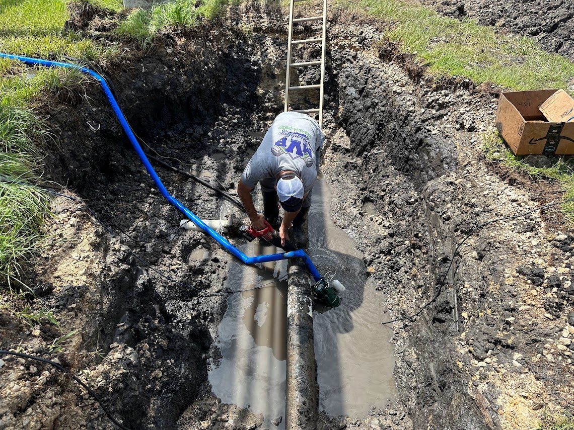 Deep trench with a large commercial water main and a ladder for access