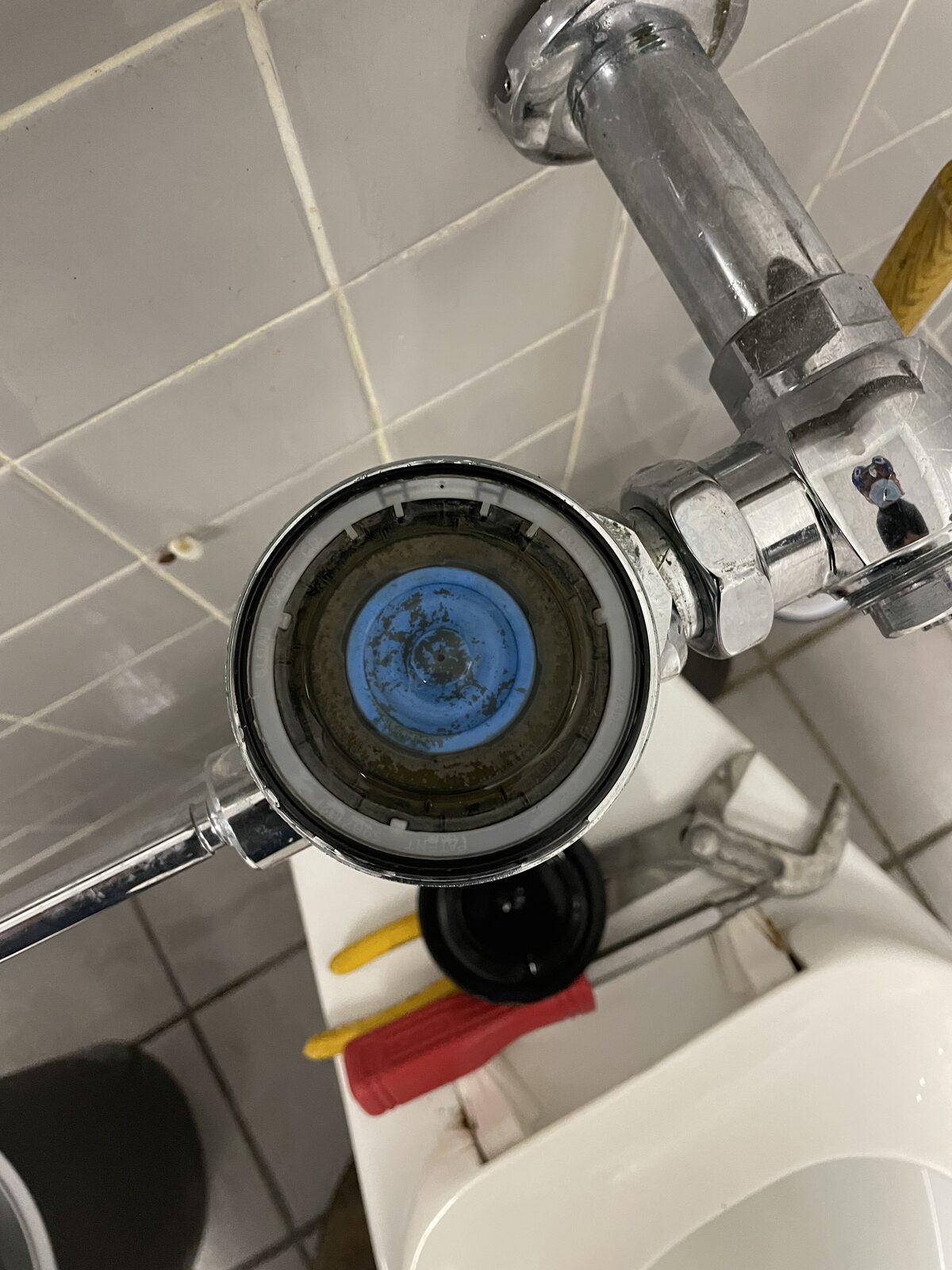 Commercial flushometer opened for a rebuild showing the diaphragm inside
