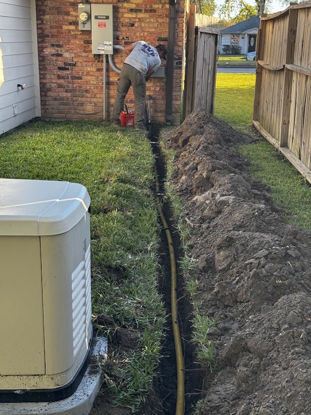 Yellow poly gas line trenched across a yard to a standby generator
