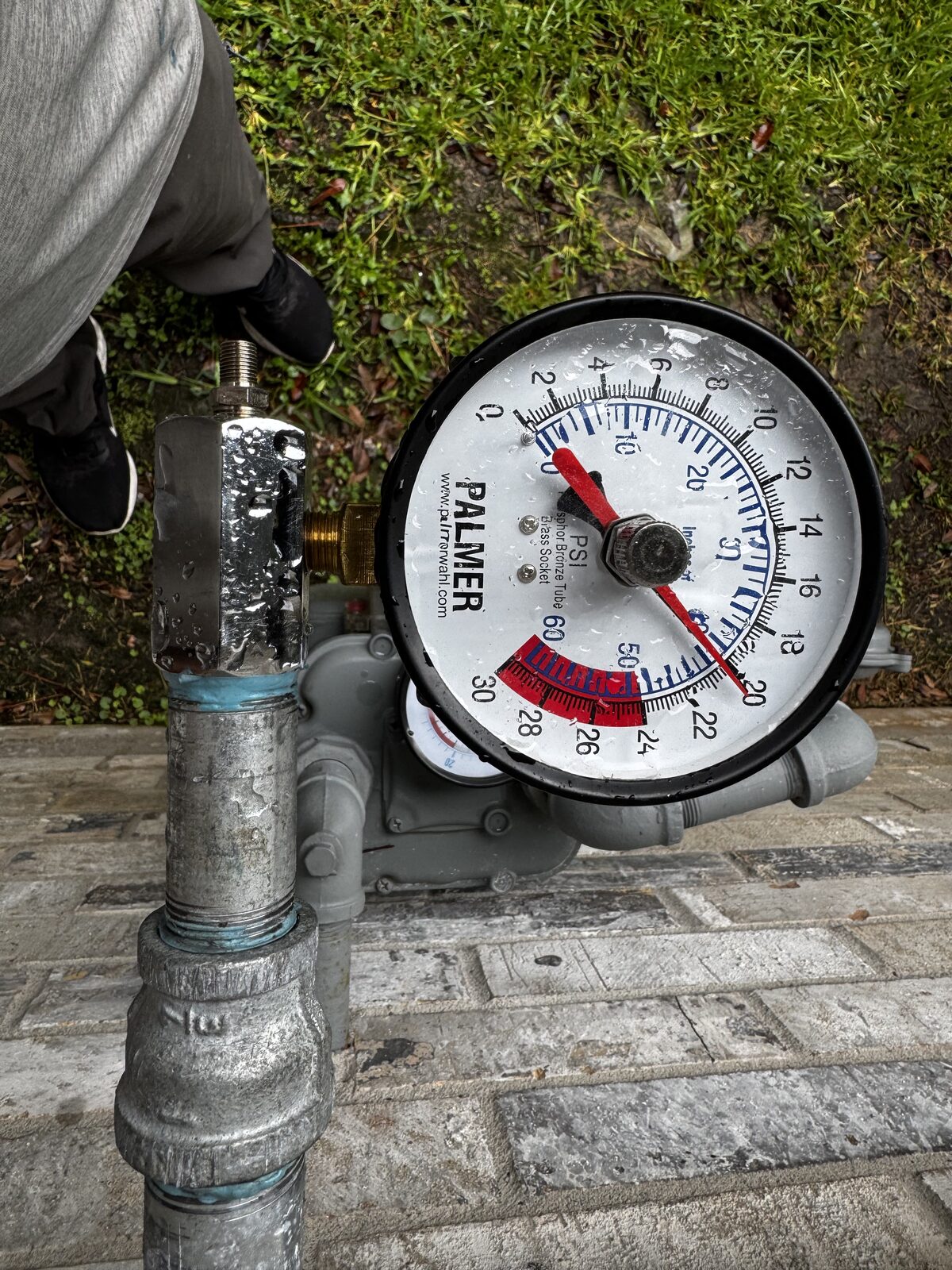 Palmer pressure gauge connected to a gas line during a pressure test