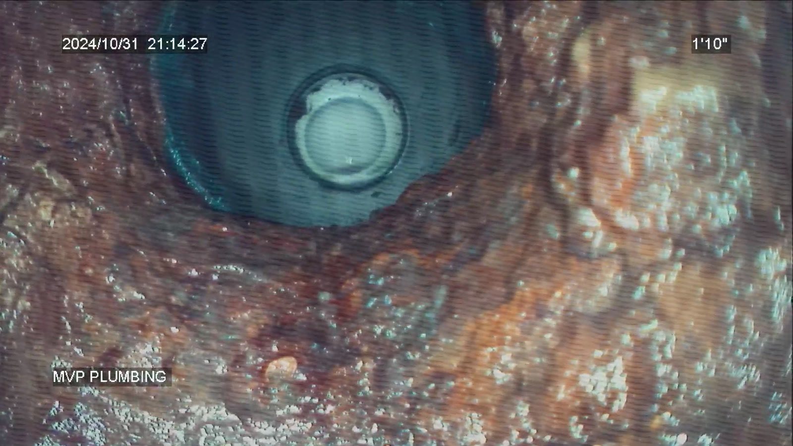 In-pipe sewer camera view of a corroded cast iron line, with MVP Plumbing overlay, date and footage counter on screen