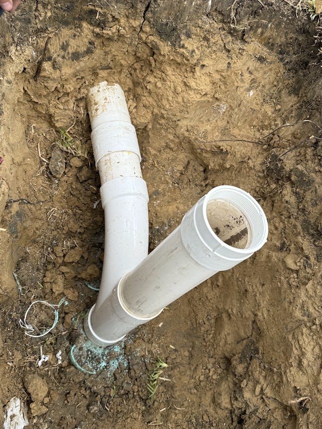 New sewer pipe fittings glued in place on the same repair