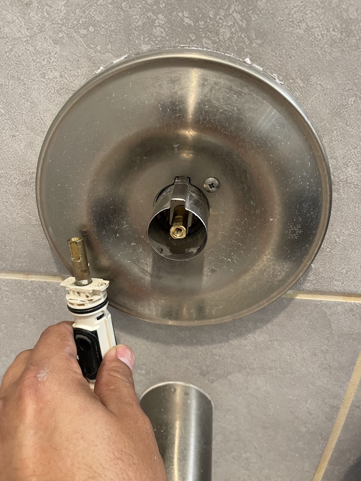 Shower valve trim removed to reach the cartridge behind it