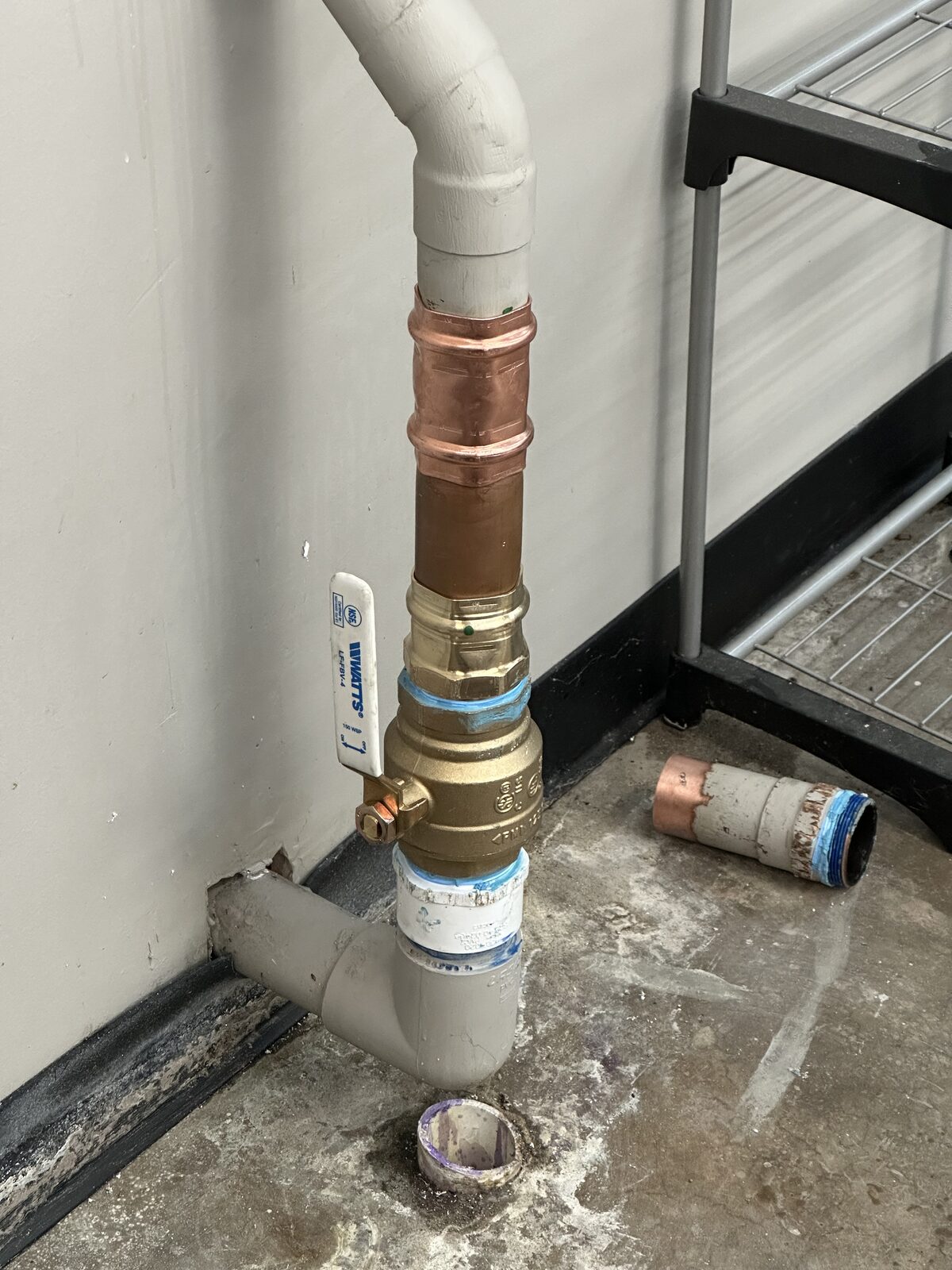 New Watts valve fitted to a two inch water main in a commercial building, with the failed cut-out section on the floor