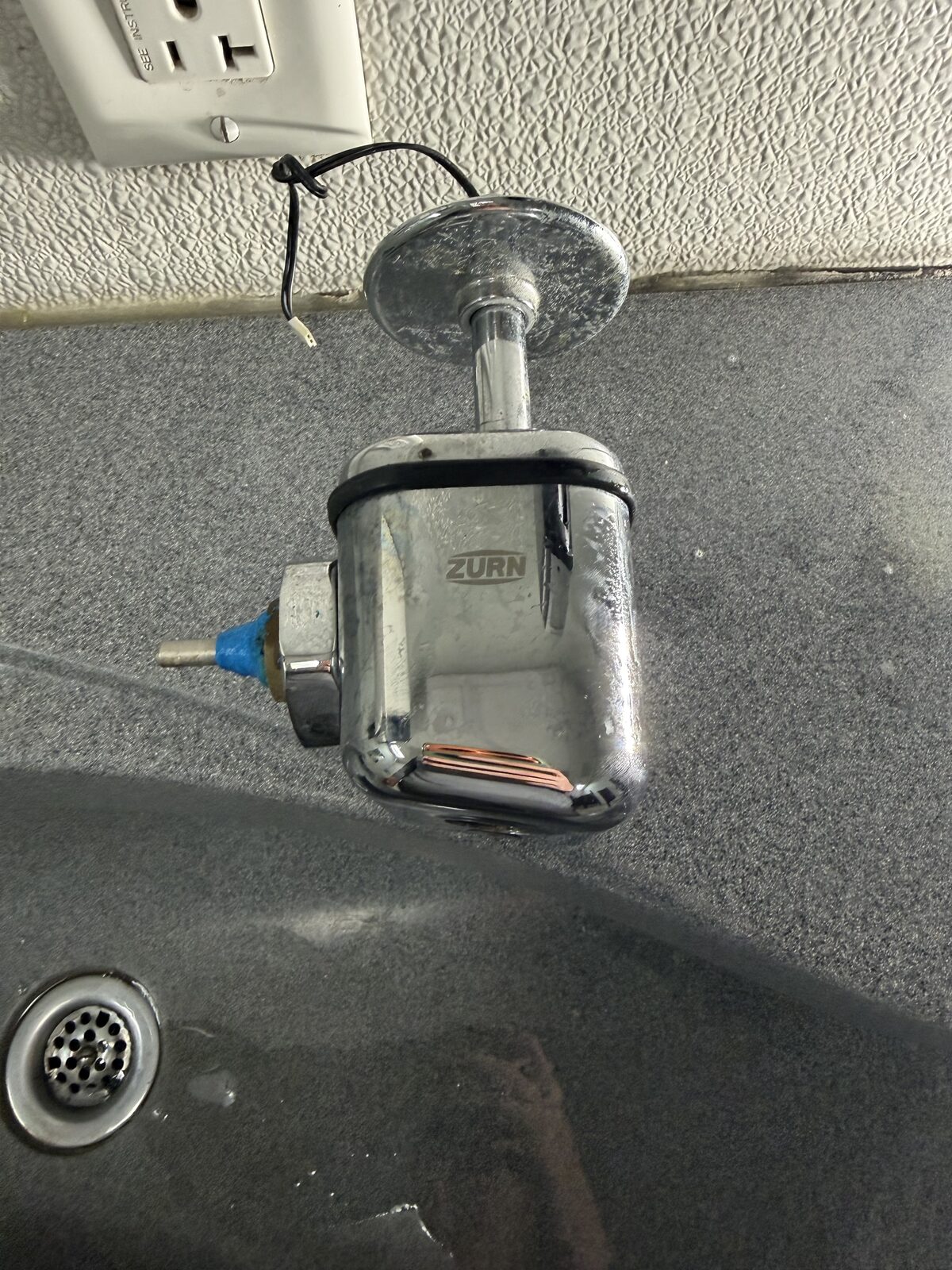 Zurn flushometer on a commercial fixture